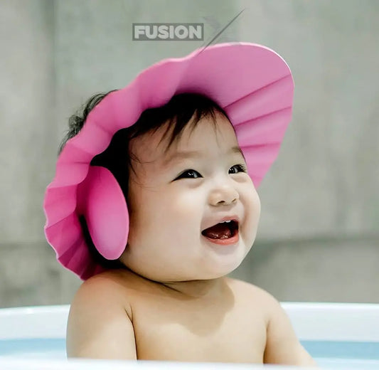 Infant wearing a Comfort Shield baby shower cap during bath time, protecting eyes and ears.